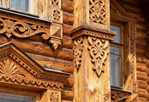 Carved wooden facade decor for exterior house finishing with columns and architraves