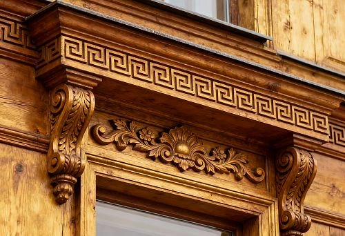 Window facade decor with carved ornament and golden elements