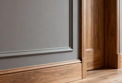 Wooden skirting boards and doorways in a unified style.