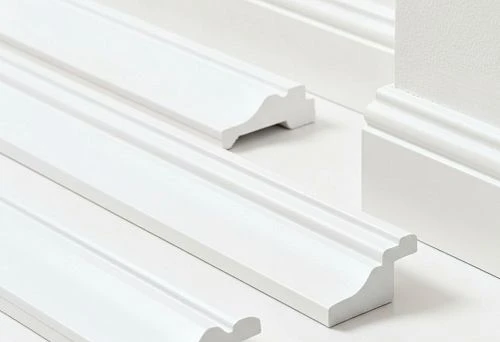 White Duropolymer and Polystyrene Skirting Boards with a Figurative Profile, Presented on a Light Background for Visual Comparison of Shapes and Materials.