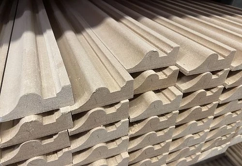 Stack of Wooden Decorative Slats with Shaped Profile for Wall Finishing in Interior