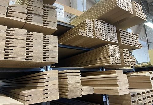 Stacks of unfinished wooden door casings with decorative profile