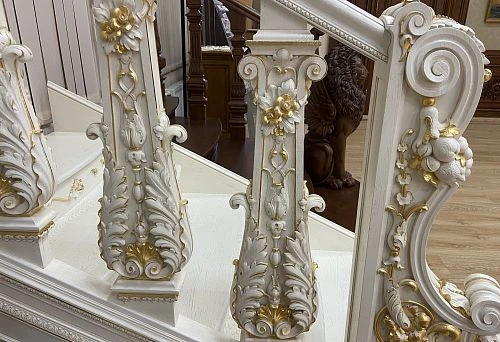 Luxurious carved decorative ornaments on the staircase with golden accents