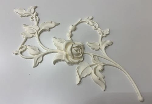 Decorative molding in the shape of a rose and elegant leaves for interior