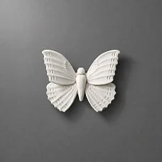 NPU-481 molding in the form of a white butterfly on a gray background.