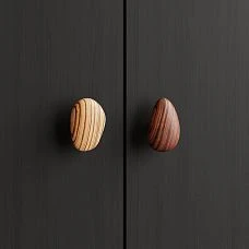 Pebble HL-065-3M furniture handle in walnut with gray oil, shaped like a smooth pebble for modern kitchens and cabinets
