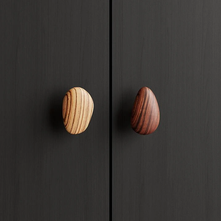 Pebble HL-065-3M furniture handle in walnut with gray oil, shaped like a smooth pebble for modern kitchens and cabinets