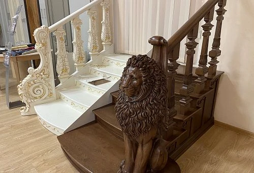 Elegant dark wooden balustrade handrail, combining smooth curves and decorative carved details,