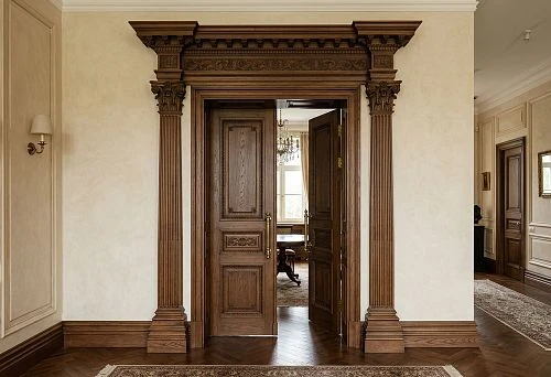 Wooden architrave, baseboard, and pilaster in the design of a classic door portal