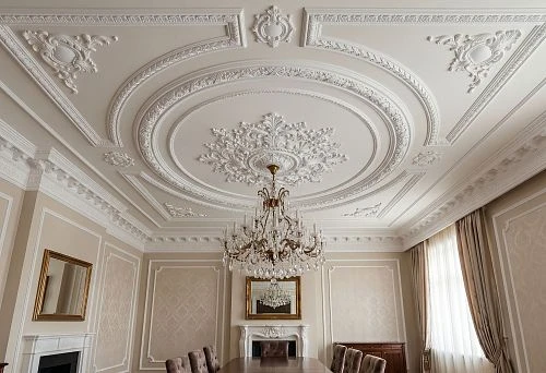 Ceiling decor around a chandelier with a rosette, moldings, and polyurethane stucco