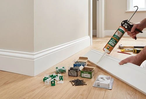 Installing MDF baseboard on the wall in a modern interior