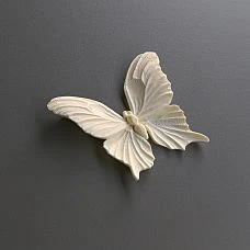 Room interior with a white chest of drawers decorated with polyurethane molding NPU-479 in the form of butterflies