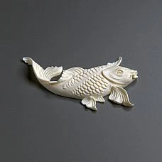 Elegant interior with a blue chest of drawers decorated with fish and plant motifs stucco.