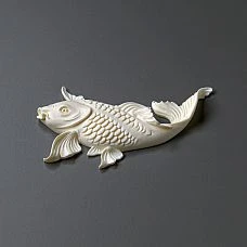Luxurious chest of drawers with golden fish stucco in the room's interior.