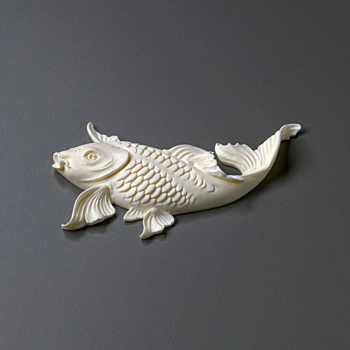 Luxurious chest of drawers with golden fish stucco in the room's interior.