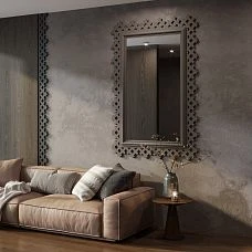 Mirror frame RM-056 in a dark color in a living room interior on a textured wall