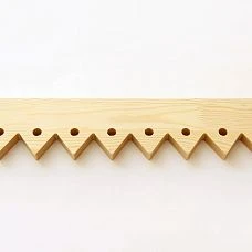 Facade of a wooden house with carved door stops NL-5