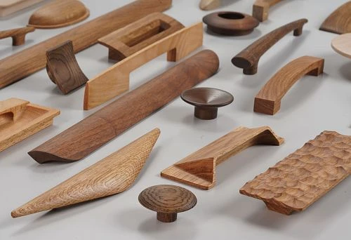 Assortment of Modern Wooden Furniture Handles in Various Shapes and Shades &ndash; Examples of Innovative Hardware for Furniture Manufacturing