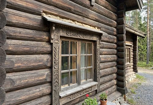 Carved window frames for a timber house on the facade