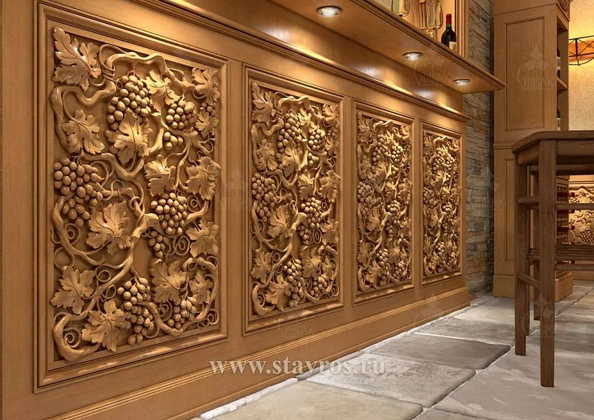 Carved wooden panels with three-dimensional grape motifs on the wine cellar wall