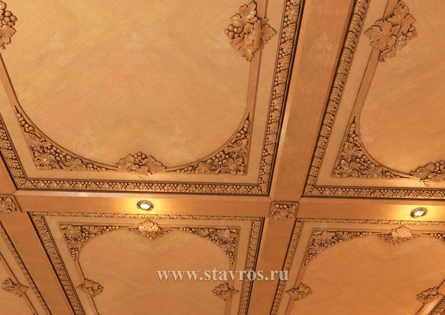 Fragment of ceiling decoration with carved cornices and built-in lighting